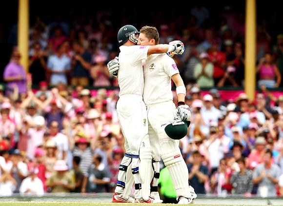 Michael Clarke (right) gets a hug from his partner Michael Hussey