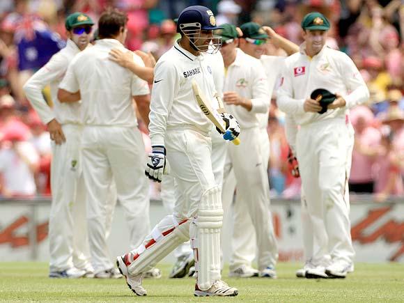 Virender Sehwag walks back after his dismissal