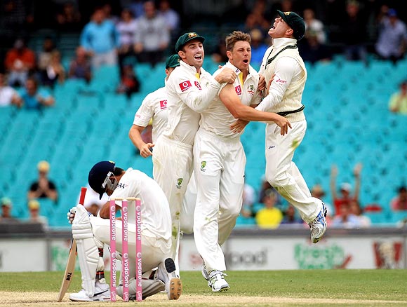 Australian players celebrate as Virat Kohli wears a dejected look after his dismissal