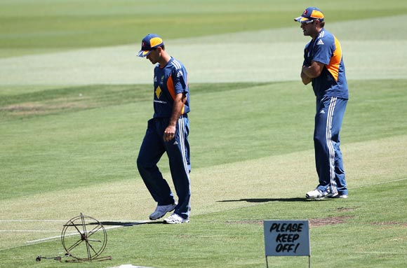 Ricky Ponting (left) and Ryan Harris check the pitch