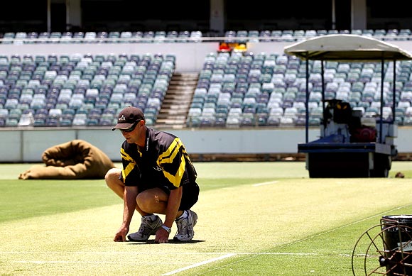 Curator Cameron Sutherland inspects the pitch at the WACA cricket stadium in Perth