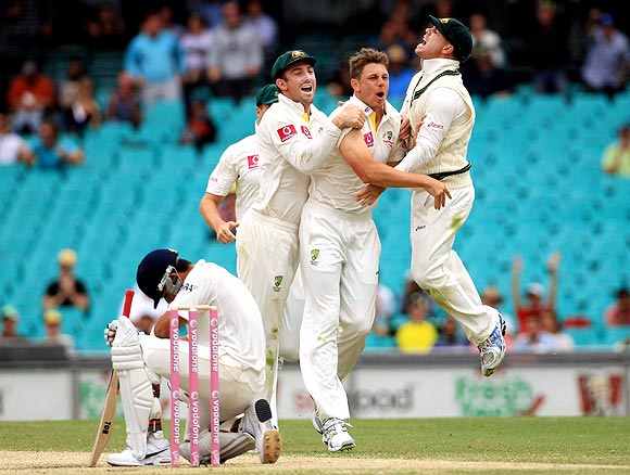Australian players celebrate after picking up a wicket