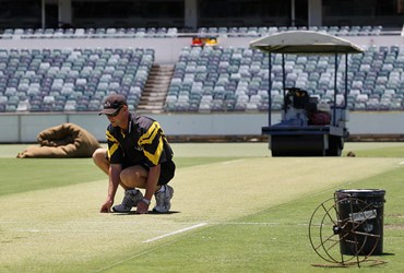 Curator Cameron Sutherland inspects the WACA pitch