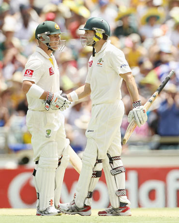 David Warner (L) and Ed Cowan of Australia reache a 200 run partnership during day two of the Third Test match between Australia and India at WACA