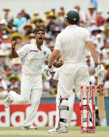 Umesh Yadav of India celebrates after taking the wicket of Shaun Marsh of Australia during day two of the Third Test match between Australia and India at WACA