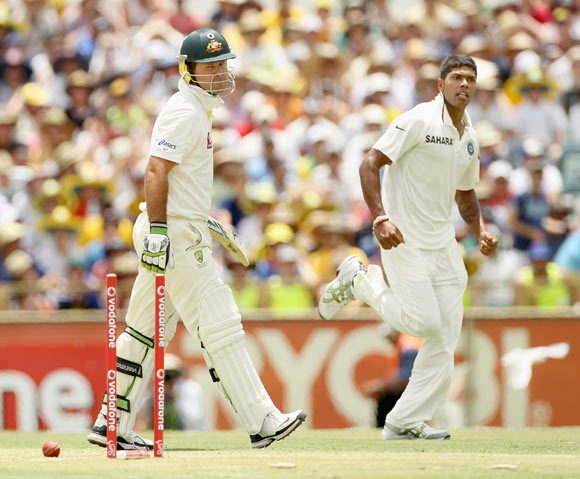 Ricky Ponting of Australia looks back at his stumps after being bowled by Umesh Yadav (R) of India during day two of the Third Test