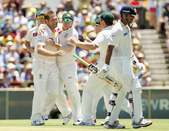 Ryan Harris of Australia celebrates with team mates after taking the wicket of Rahul Dravid of India during day three of the Third Test