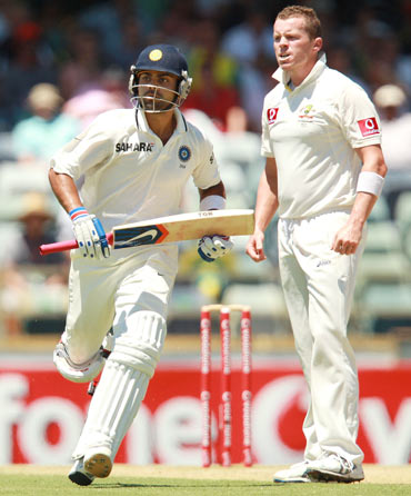 Virat Kohli of India runs past Peter Siddle of Australia during day three of the Third Test match between Australia and India at the WACA