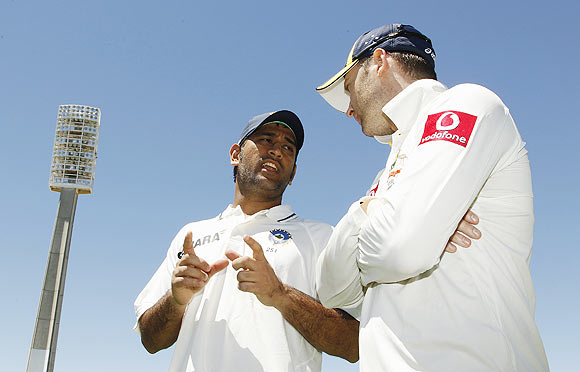 Australia's captain Michael Clarke (right) talks to India's captain Mahendra Singh Dhoni after Australia won the third Test on Sunday