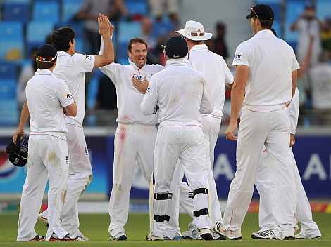 Graeme Swann celebrates after picking up the wicket of Misbah ul Haq