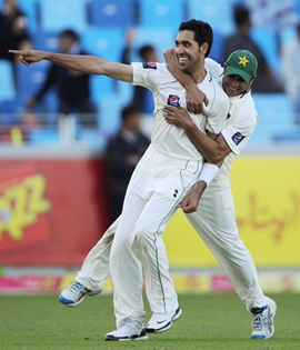 Umar Gul celebrates with Abdur Rehman after dismissing Jonathan Trott