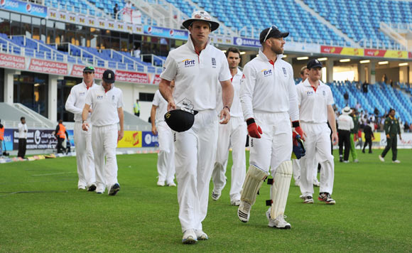 Captain Andrew Strauss of England leads his team from the field after defeat in the first Test match between Pakistan and England at The Dubai International Cricket Stadium