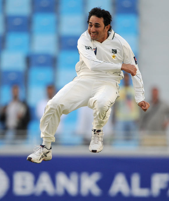 Saeed Ajmal of Pakistan celebrates dismissing Graeme Swann of England and taking his 10th wicket of the match during the first Test match