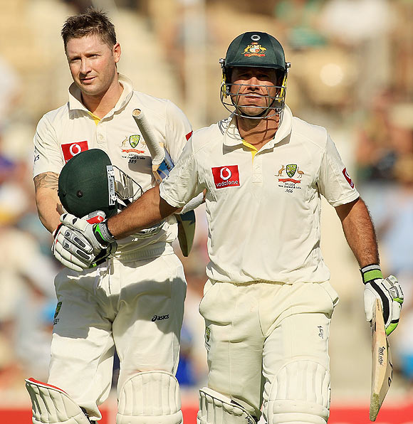 Ricky Ponting (right) and Michael Clarke leave the field at the end of the first day's play on Monday