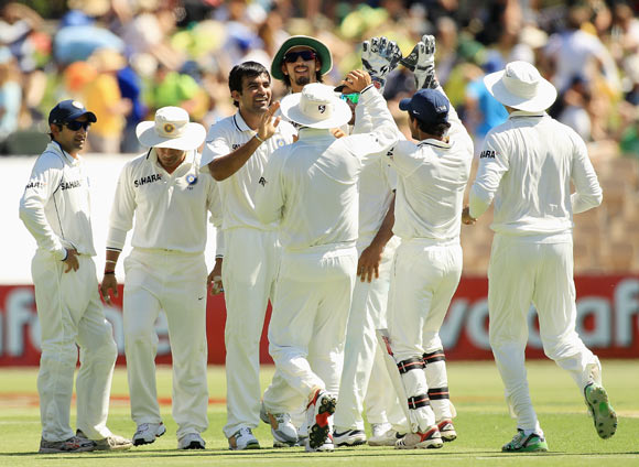 Zaheer Khan celebrates with team mates after taking the wicket of David Warner during day one of the fourth Test