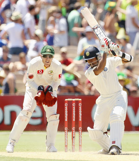 Wriddhiman Saha of India hits out with Brad Haddin of Australia looking on during day three of the Fourth Test