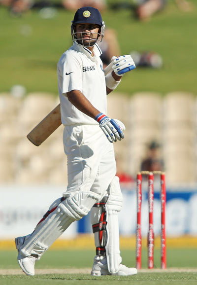 Virat Kohli leaves the field after being run-out