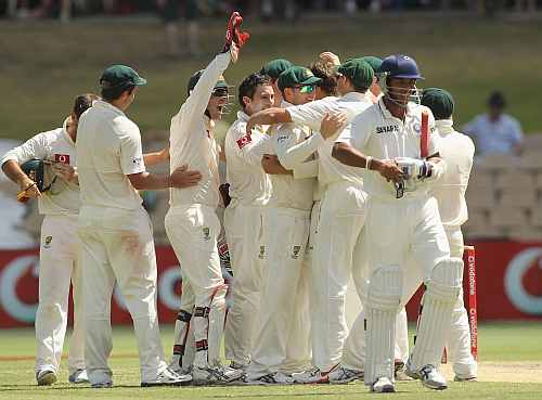 Australian's celebrate after picking up the wicket of Umesh Yadav at the Adelaide Oval