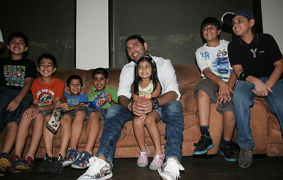 Cancer survivor Yuvraj Singh plays with kids during the launch of  YouWeCan, a cancer-awareness programme in New Delhi