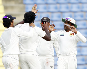 Sri Lankan team celebrates the fall of a wicket