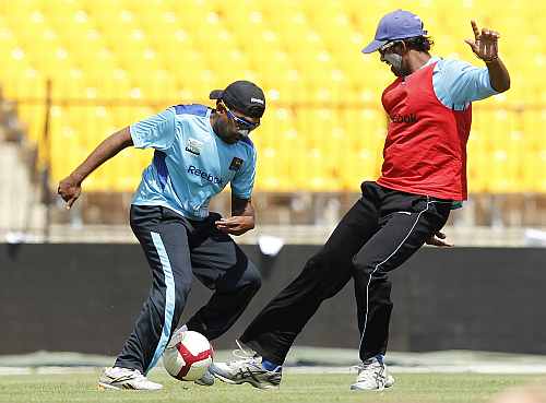 Sri Lanka's captain Mahela Jayawardene (L) and Sachithra Senanayake play football during a practice session