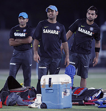 India's captain Mahendra Singh Dhoni (centre) and vice-captain Virat Kohli (right) at a practice session ahead of their first ODI against Sri Lanka in Hambantota