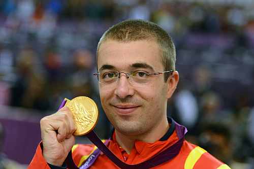 Gold medallist Alin George Moldoveanu of Romania poses with the gold medal won in the Men's 10m Air Rifle Shooting