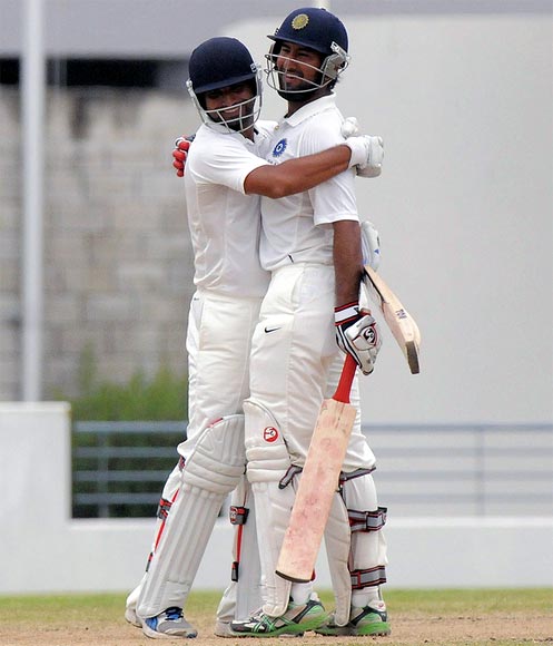 Cheteshwar Pujara (right) and Shami Ahmed celebrate winning the match