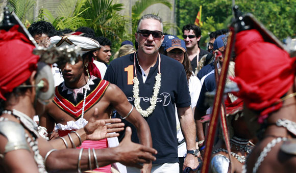 Former England cricket player Ian Botham arrives at Seenigama Oval cricket ground in December 2009