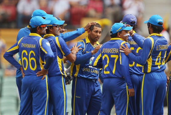 Tillakaratne Dilshan of Sri Lanka is congratulated by his team mates after taking the wicket of Matthew Wade of Australia during the second One Day International Final