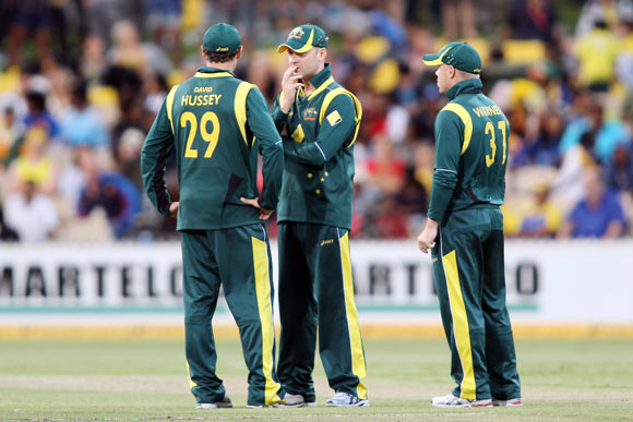 David Hussey, Michael Clarke and David Warner of Australia talk between overs during the second One Day International Final series match