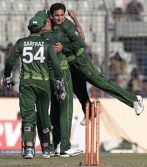 Ajmal is congratulated by teammates after dismissing Farveez Mahroof