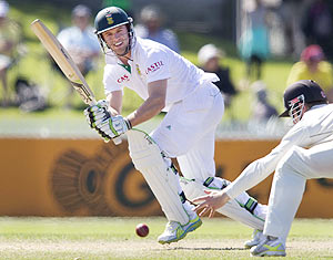 South Africa's AB de Villiers plays a shot past Kane Williamson of New Zealand on day two of the second Test match in Hamilton on Friday