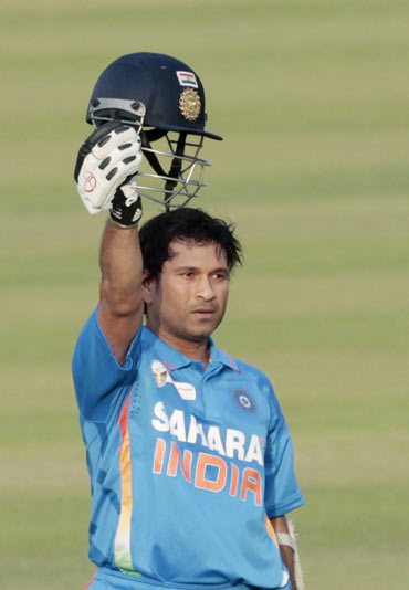 India's Sachin Tendulkar celebrates after he scored his 100th international century during their Asia Cup one- day international (ODI) cricket match against Bangladesh in Dhaka