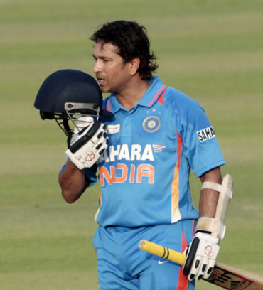 India's Sachin Tendulkar celebrates after he scored his 100th international centuries during their Asia Cup one- day international (ODI) cricket match against Bangladesh in Dhaka