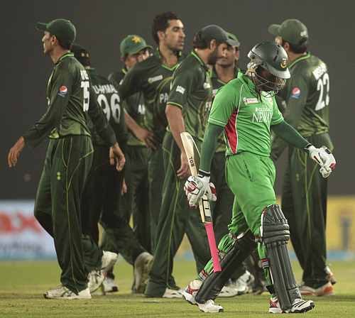 Bangladesh's captain Mushfiqur Rahim leaves the field as Pakistan's fielders celebrate his dismissal