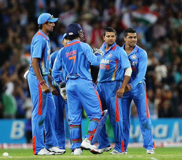 Suresh Raina (C) of India is swamped by team mates after his good fielding