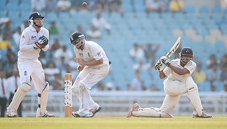 Hiken Shah of Mumbai A strikes the ball past Ian Bell and Jonathan Bairstow of England