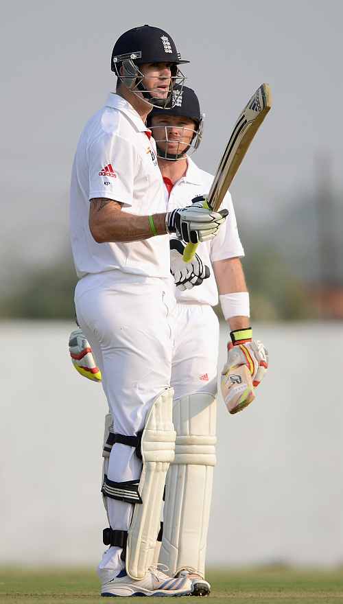 Kevin Pietersen of England raises his bat after reaching his century during the tour match between England and Haryana