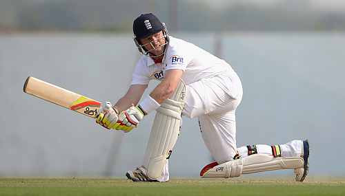 Ian Bell plays a sweep shot during the tour match between England and Haryana