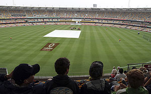 The pitch area is covered as it rains on the second day of the first Test between South Africa and Australia at the Gabba in Brisbane on Saturday
