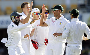 South Africa's Morne Morkel (2nd from left) celebrates with teammates after the dismissal of Australia's Ricky Ponting during the first Test at the Gabba in Brisbane on Sunday
