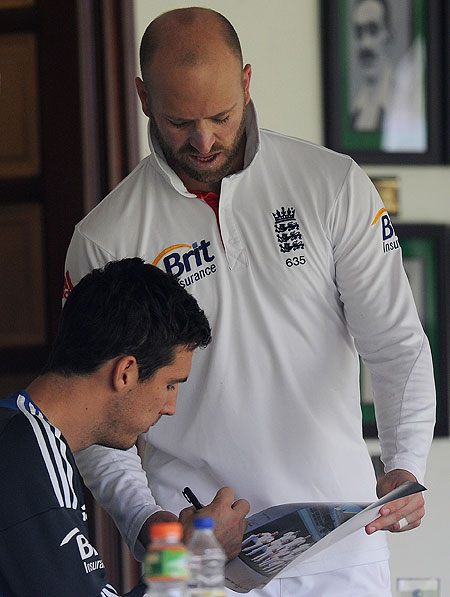Matt Prior of England (right) gets a picture signed by teammate Steve Finn