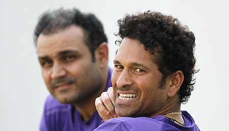 India's Sachin Tendulkar (right) and Virender Sehwag watch during a practice session in Ahmedabad on Tuesday