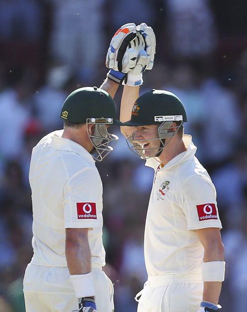 Australia's captain Michael Clarke (R) congratulates teammate Mike Hussey on reaching his century during the second cricket Test match against South Africa