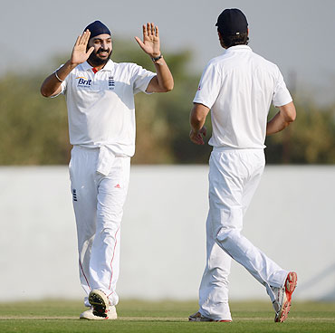 Monty Panesar of England celebrates with Alastair Cook