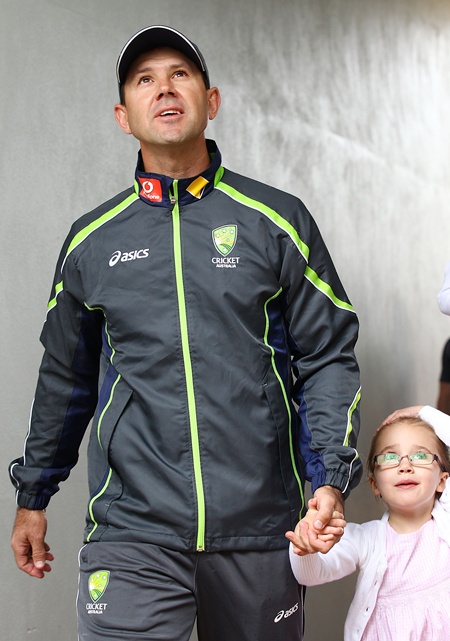 Australian cricket player Ricky Ponting walks with his daughter