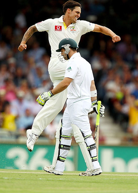 Australia's Mitchell Johnson celebrates the wicket of Dean Elgar of South Africa on day 1 of the Third Test between Australia and South Africa at WACA