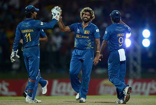 Lasith Malinga of Sri Lanka celebrates with Kumar Sangakkara and Jeevan Mendis after bowling Samit Patel of England during the ICC World Twenty20 2012 Super Eights Group 1 match between Sri Lanka and England