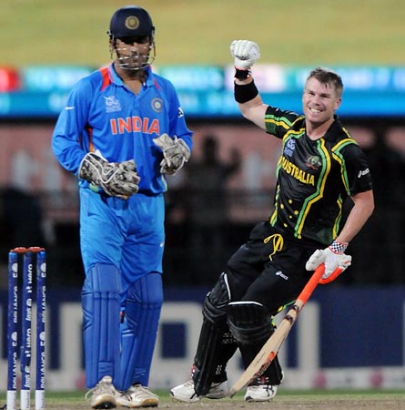 India captain Mahendra Singh Dhoni looks on as Australia's David Warner